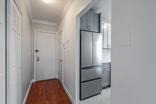 corridor with crown molding and light hardwood / wood-style flooring