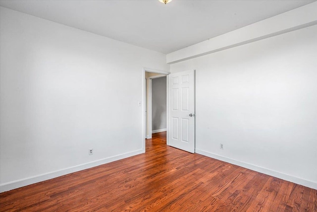 spare room with hardwood / wood-style floors