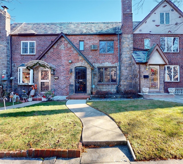 tudor home with a front lawn