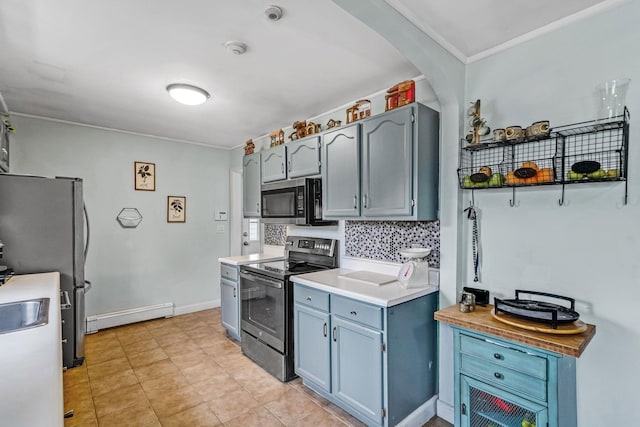 kitchen featuring blue cabinetry, appliances with stainless steel finishes, backsplash, and baseboard heating