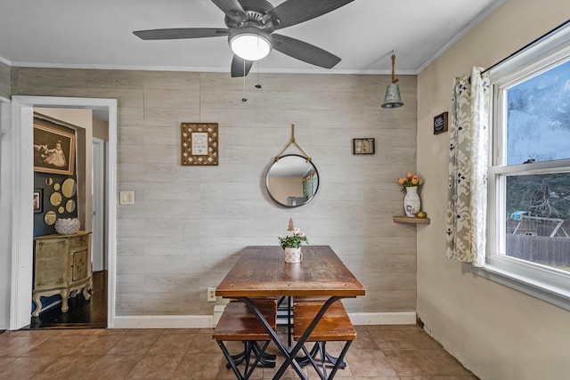 dining space featuring tile patterned floors, ceiling fan, and crown molding