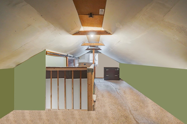 additional living space with light carpet and vaulted ceiling