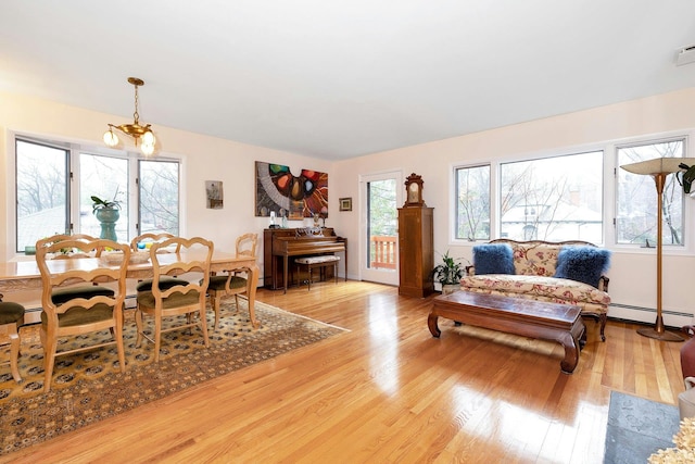 living room featuring baseboard heating and light wood-type flooring