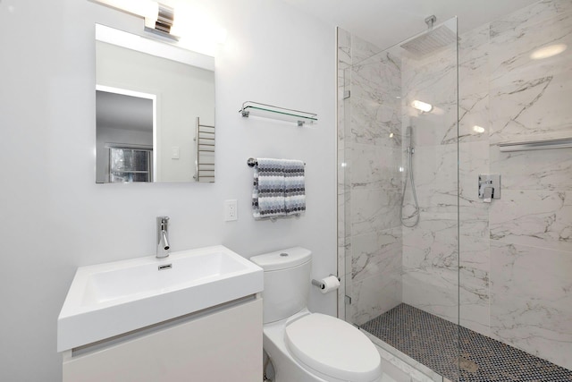 bathroom with vanity, toilet, and tiled shower