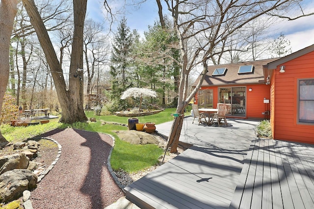 wooden terrace with a lawn