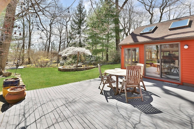 wooden terrace with a lawn