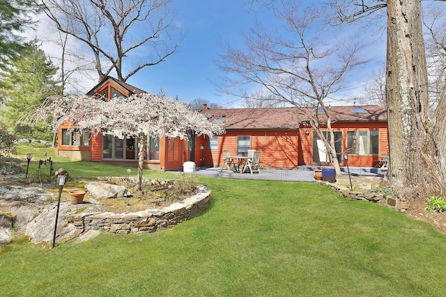 back of house featuring a yard and a patio