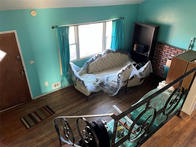 living room with dark hardwood / wood-style floors and vaulted ceiling