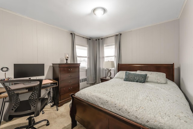 carpeted bedroom with wood walls, ornamental molding, and radiator