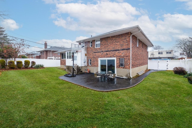 rear view of property featuring a yard and a patio