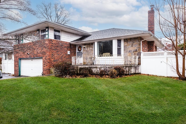 tri-level home with a front lawn and a garage