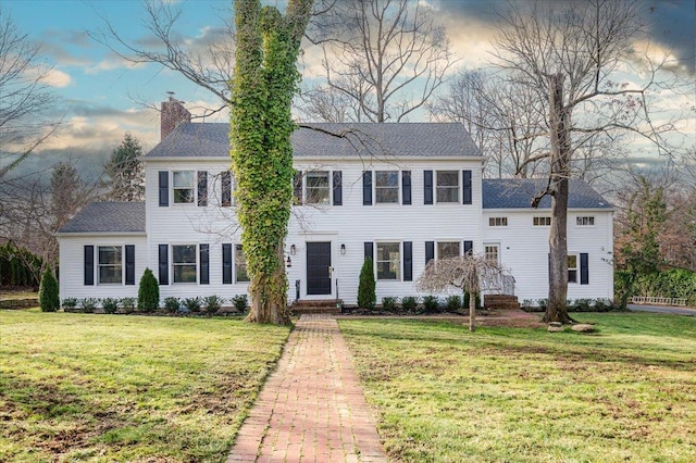 colonial-style house with a yard