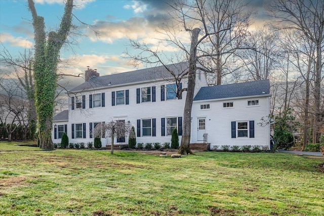 colonial inspired home featuring a lawn