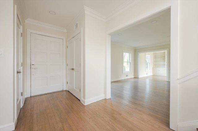 corridor featuring light hardwood / wood-style flooring and ornamental molding