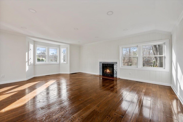 unfurnished living room featuring crown molding and dark wood-type flooring