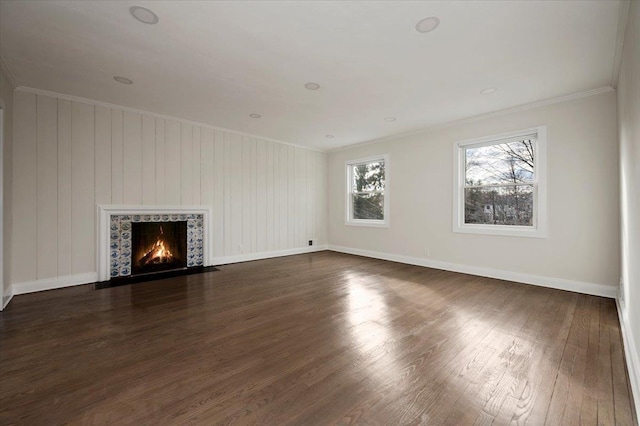 unfurnished living room with a fireplace, dark hardwood / wood-style floors, and crown molding