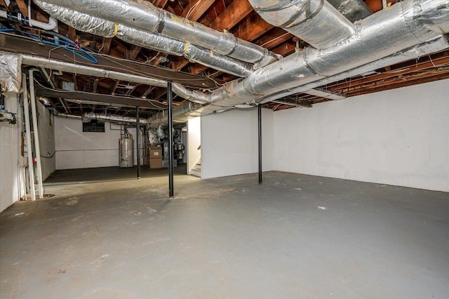 basement featuring heating unit and water heater