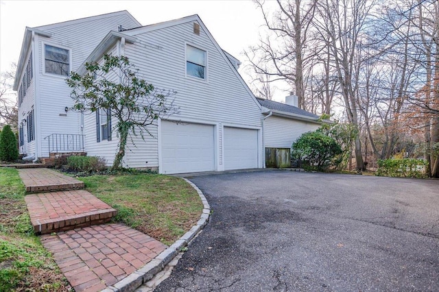 view of side of property with a garage