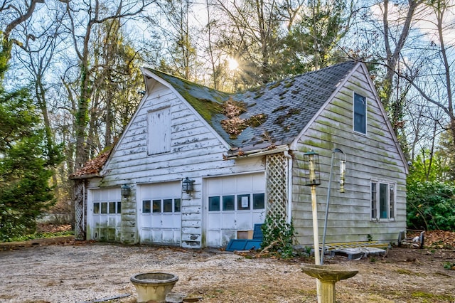 view of home's exterior with an outbuilding and a garage