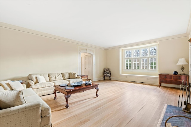 living room with light hardwood / wood-style floors and ornamental molding