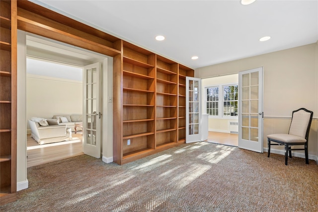 unfurnished room featuring hardwood / wood-style flooring, radiator, and french doors