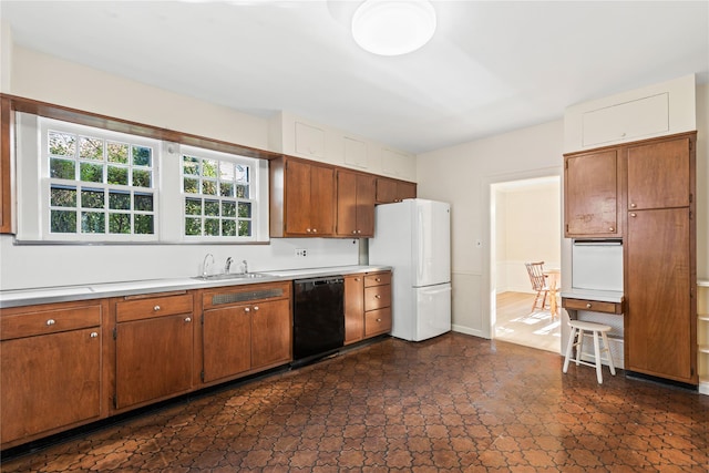 kitchen with dishwasher, white refrigerator, and sink