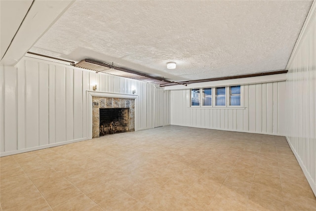 unfurnished living room with a textured ceiling and ornamental molding