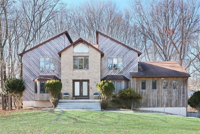 view of front of house with french doors and a front lawn