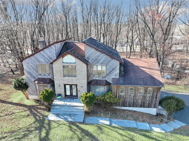 view of front of home with a front lawn and french doors