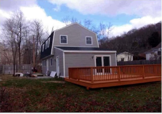 back of house with a wooden deck