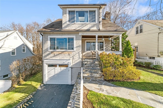 view of front of house featuring a front yard and a garage