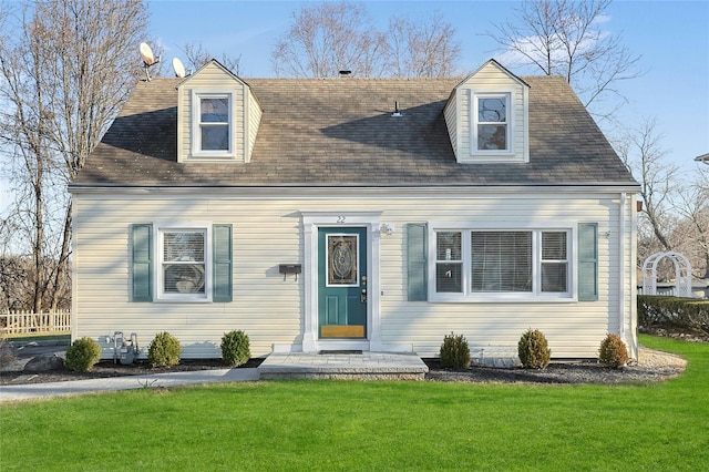 cape cod house featuring a front yard