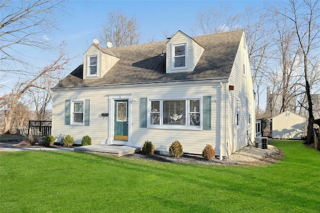 cape cod-style house featuring a front lawn and central air condition unit