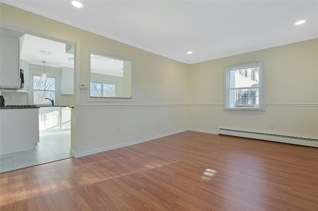 spare room with light hardwood / wood-style floors and a wealth of natural light