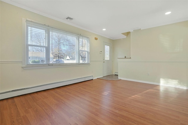 unfurnished room featuring light hardwood / wood-style floors, ornamental molding, and a baseboard radiator