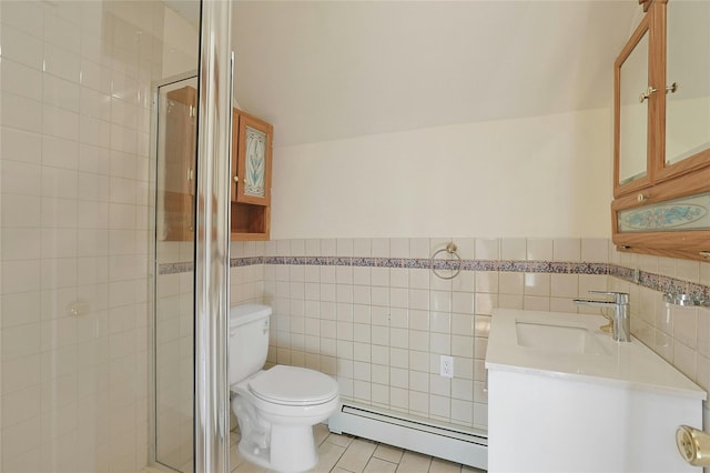 bathroom with tile patterned flooring, vanity, a baseboard radiator, and tile walls