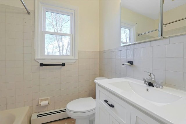 bathroom with vanity, toilet, tile walls, and a baseboard heating unit