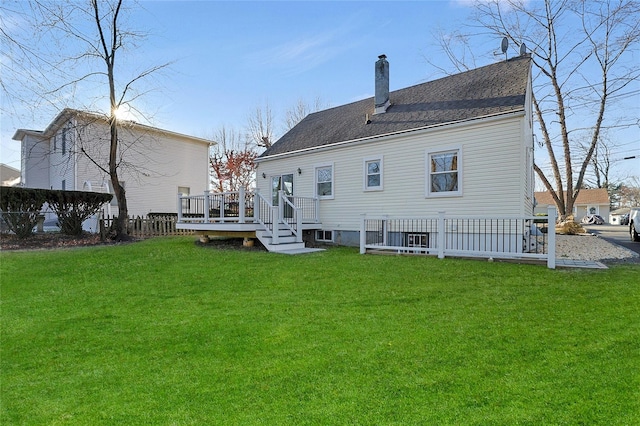 rear view of house with a lawn and a deck