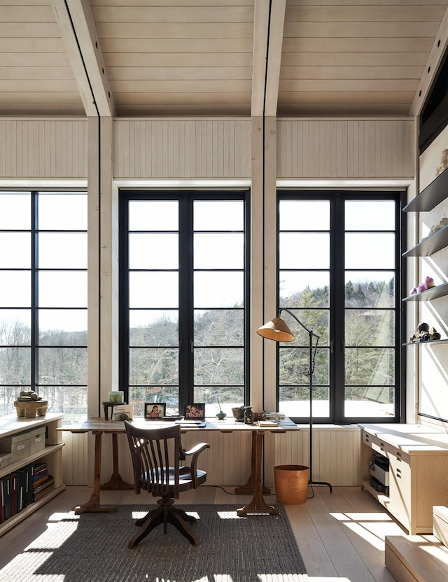 unfurnished sunroom featuring beam ceiling and wood ceiling