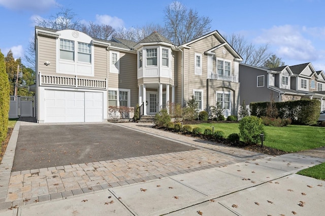 view of property with a garage and a front yard