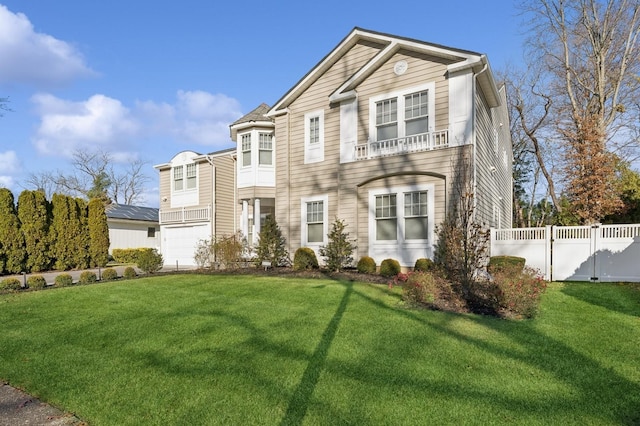 view of front of home with a front yard and a garage