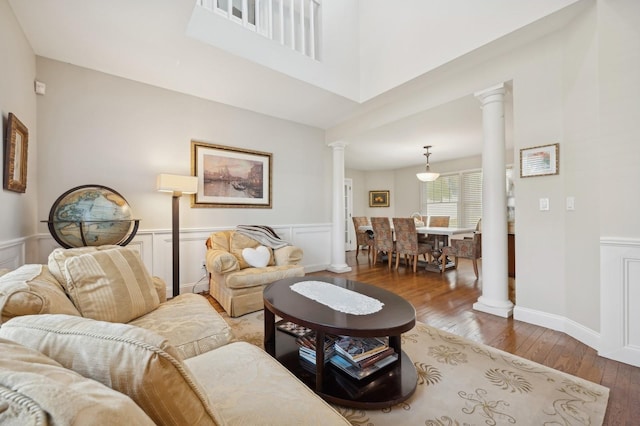 living room with ornate columns and wood-type flooring