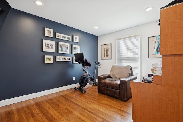 workout area with hardwood / wood-style floors