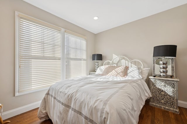 bedroom with dark hardwood / wood-style flooring