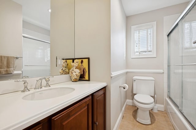 full bathroom with tile patterned flooring, vanity, toilet, and bath / shower combo with glass door