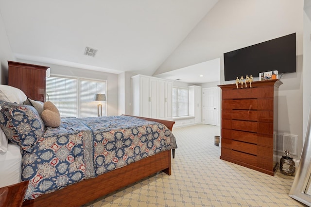 carpeted bedroom featuring high vaulted ceiling and multiple windows