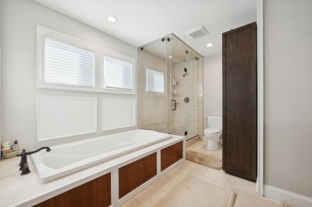 bathroom featuring separate shower and tub, tile patterned floors, and toilet