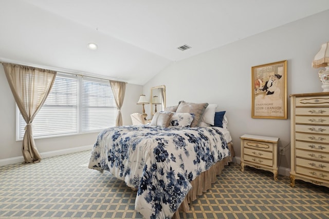 bedroom with carpet floors and vaulted ceiling