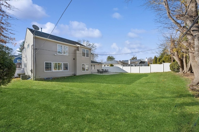 back of property with a yard and cooling unit