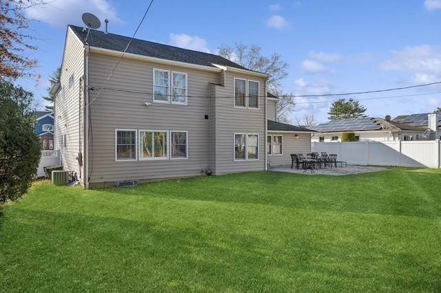 back of property featuring a patio area, a yard, and central air condition unit